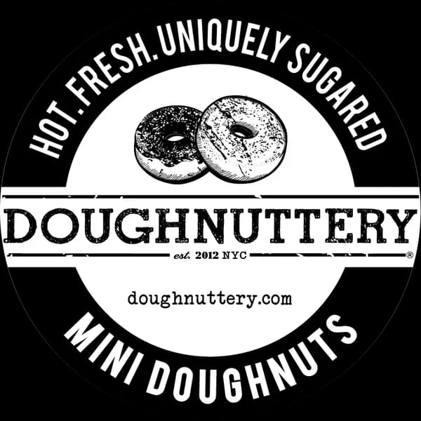 Doughnuttery round black-and-white logo reading Hot, Fresh, Uniquely Sugared Mini Doughnuts