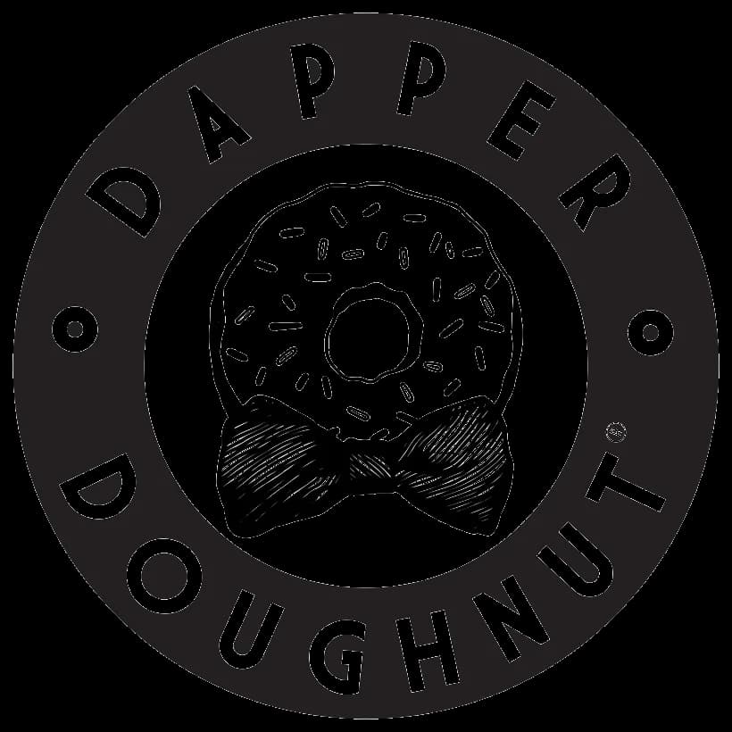 The Dapper Doughnut round black-and-white logo showing a sprinkled doughnut wearing a bow tie